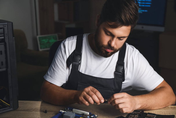 Technician repairing computer in service center - Photo, Image