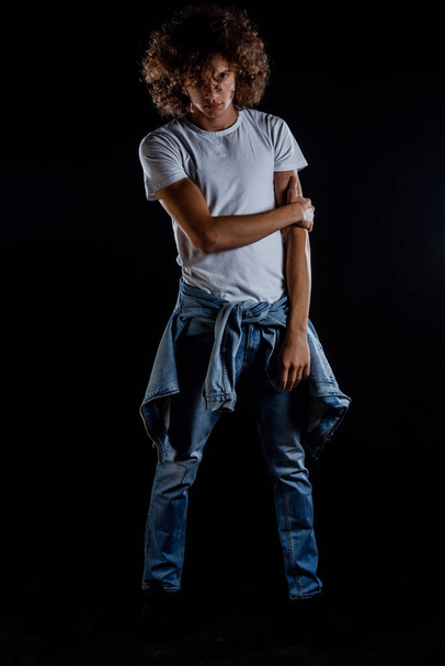 Stylish fashion guy wearing white t-shirt blue jeans and sneakers - Fotografie, Obrázek