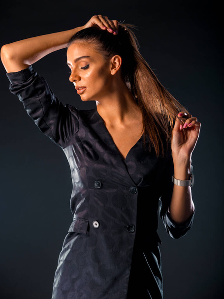 Studio body shot of a fashion female model posing in modern clothing - Фото, изображение