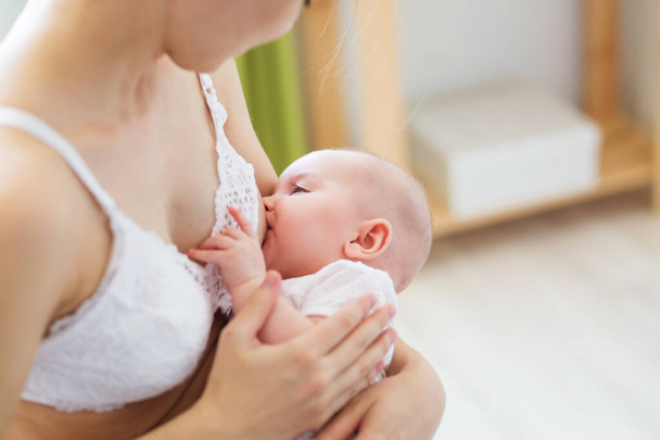 Mother breast feeding her little boy. Mom nursing and feeding baby. Close-up portrait of infant. - Zdjęcie, obraz