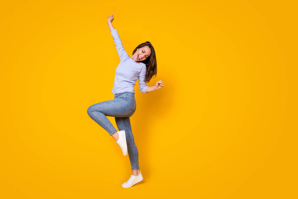 Full length body size view of her she attractive lovely carefree cheerful cheery girl having fun dancing chill out rest relax cool party isolated bright vivid shine vibrant yellow color background - Fotó, kép