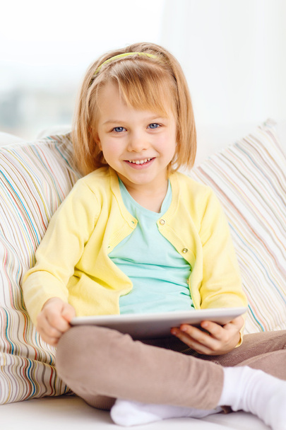Smiling girl with tablet pc computer at home - Фото, зображення