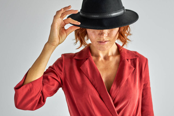 fashion model in black hat looking down - Photo, image