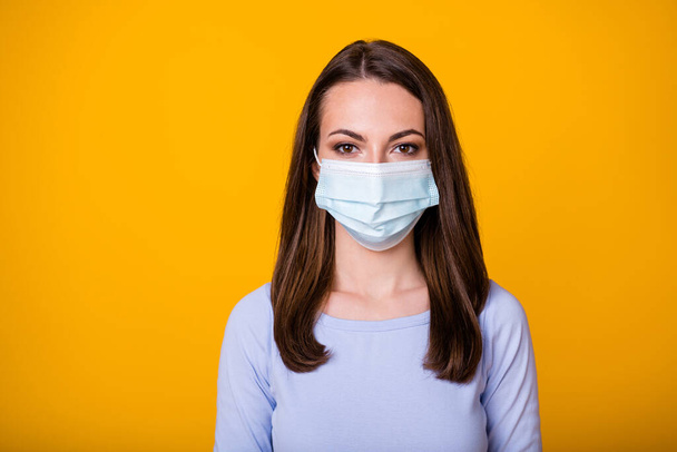 Close-up portrait of her she attractive pretty brown-haired girl wearing safety mask stop flue gripe viral pneumonia symptom syndrome isolated bright vivid shine vibrant yellow color background - Foto, imagen