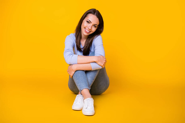 Portrait of her she nice attractive lovely cheerful cheery girl sitting on floor enjoying free time rest relax wearing cozy dressing isolated bright vivid shine vibrant yellow color background - Foto, Imagem