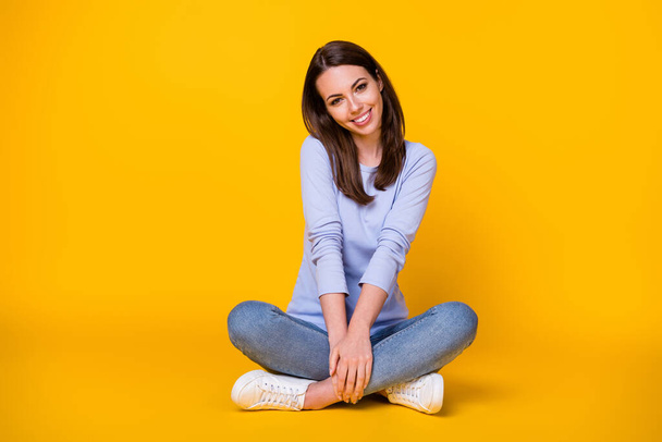Portrait of her she nice attractive pretty cute sweet shy modest cheerful cheery girl sitting lotus position enjoying isolated bright vivid shine vibrant yellow color background - Fotó, kép