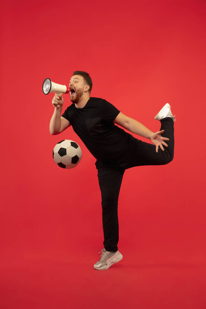 Full length portrait of young successfull jumping man gesturing isolated on red studio background - Photo, image