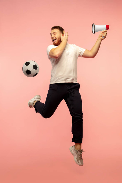 Full length portrait of young successfull high jumping man gesturing isolated on pink studio background - Photo, image
