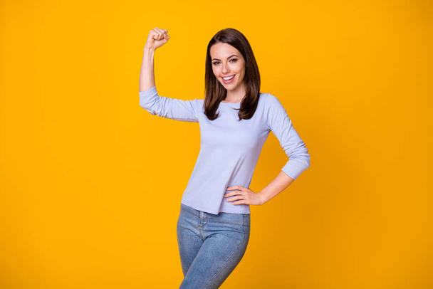 Photo of positive cheerful girl enjoy gym workout training show hands muscles wear good look clothes isolated over shine color background - Fotoğraf, Görsel