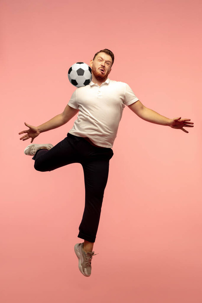 Full length portrait of young successfull high jumping man gesturing isolated on pink studio background - Fotoğraf, Görsel