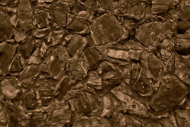 Абстрактный фон многих крупных камней. Пустая каменная поверхность темного цвета. - Фото, изображение