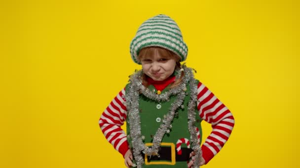 Displeased girl in Christmas elf Santa helper costume looking unhappily angry, sad. Negative emotion - Footage, Video