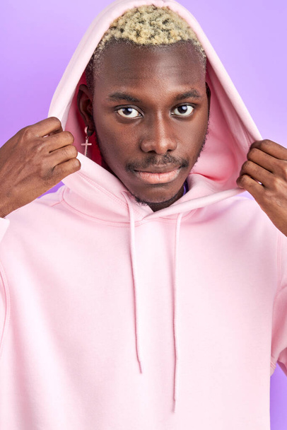 calm afro man is wearing hood of pullover - Valokuva, kuva