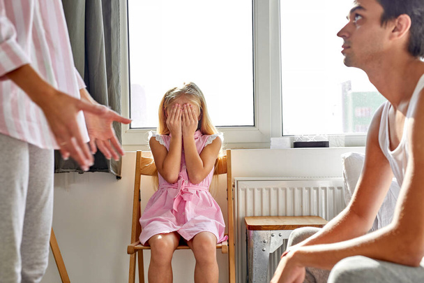 sad girl daughter suffering from parents quarrel, domestic violence and family conflict concept - 写真・画像