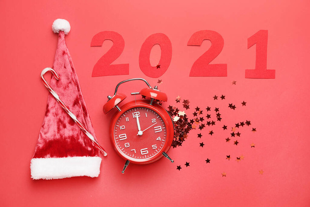 New Year composition with alarm clock and figure 2021 on color background - Photo, Image