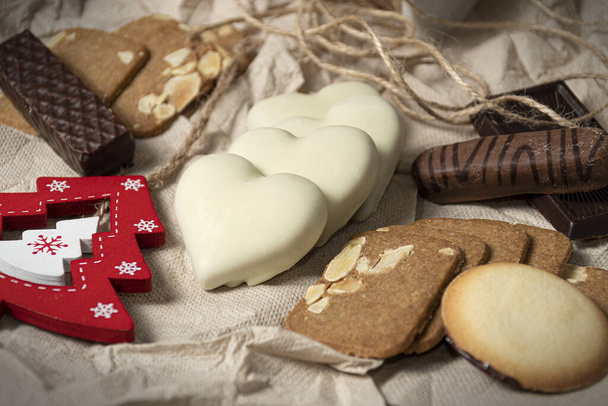 A selective focus shot of delicious cookies in various shapes and a little Christmas tree decoration - Foto, Imagen
