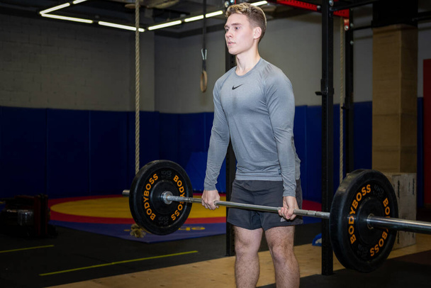 Young athlete men has fit training with barbell in the gym - Fotó, kép