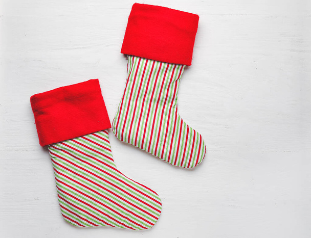 Christmas socks on white wooden background - 写真・画像
