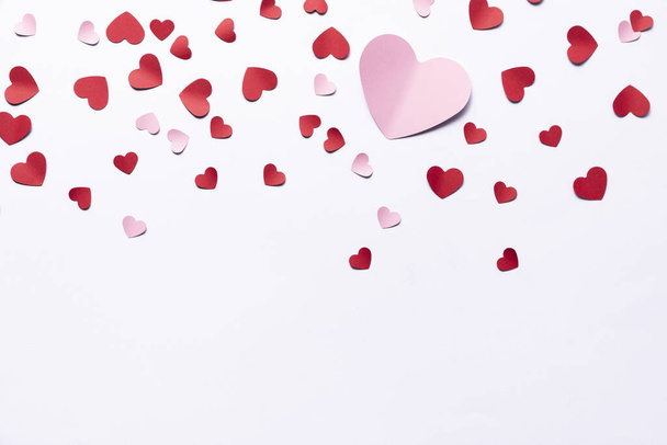 A beautiful shot of paper hearts on a white background- Valentine concept - Fotó, kép