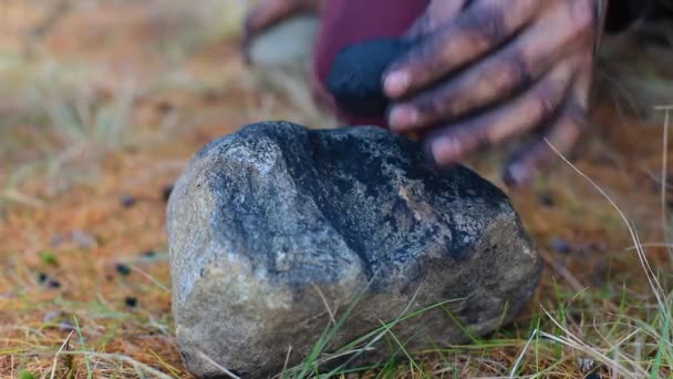 Man breaking charcoal rock into pieces - Footage, Video