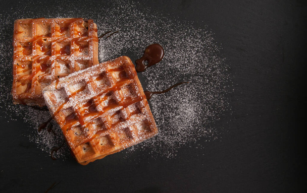 toasted chocolate chip waffles with caramel and powdered sugar - Photo, Image