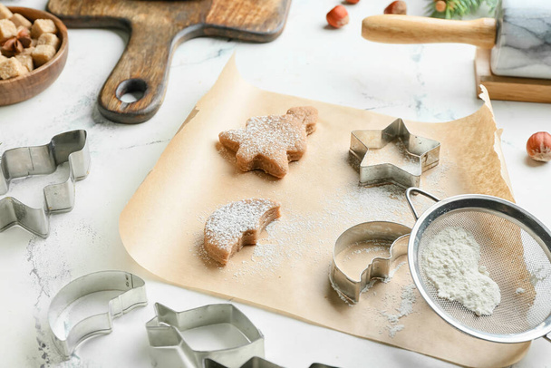 Fresh dough for gingerbread cookies and cutters on table - Fotoğraf, Görsel