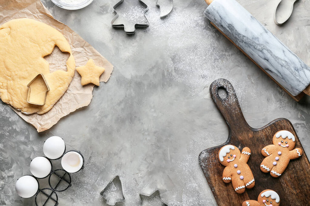 Fresh dough for gingerbread cookies and cutters on grunge background - Foto, imagen