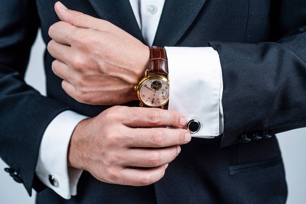 Modern horology. Wrist watch worn with formal suit. Portable timepiece. Time management. Horology concept. Professional punctuality. Business etiquette - Foto, afbeelding