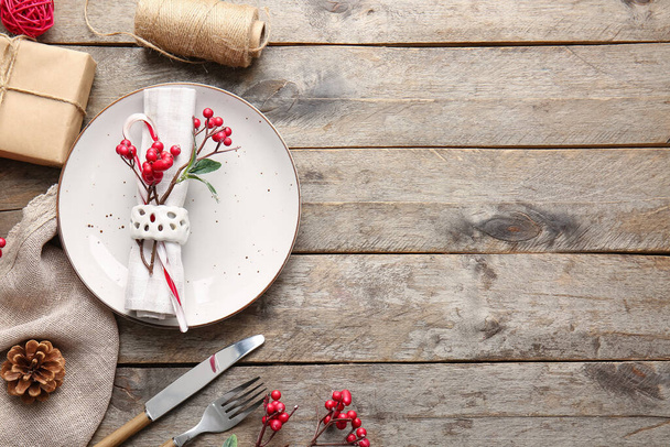 Beautiful Christmas table setting with mistletoe on wooden background - Photo, Image