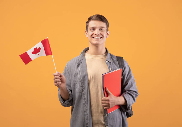 Canada day, patriotism and knowledge sharing. Millennial smiling european guy - Photo, Image