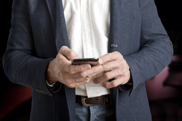 Casual Businessman messaging on a phone - Фото, зображення