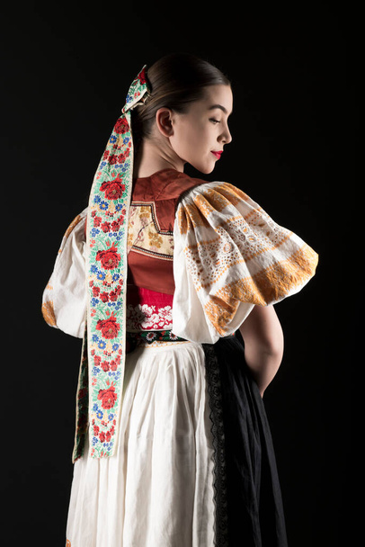 Young beautiful slovak woman in traditional dress. Slovak folklore - Фото, изображение