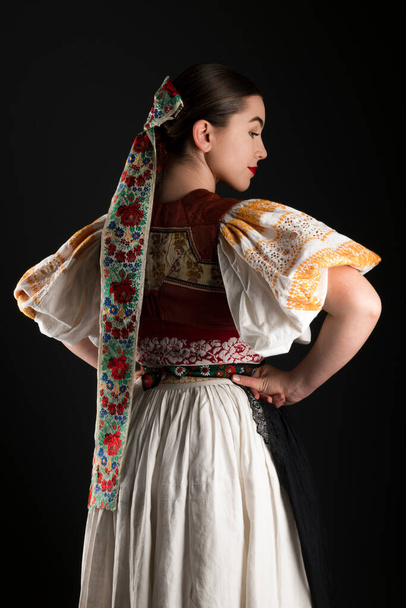 Young beautiful slovak woman in traditional dress. Slovak folklore - Zdjęcie, obraz