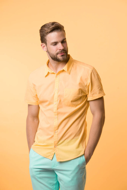 Casual style. Man on calm face posing confidently put hands pockets. Man attractive in casual shirt. Guy fashion model wear casual shirt. Feel comfortable in simple outfit. Casual comfortable outfit - Foto, afbeelding