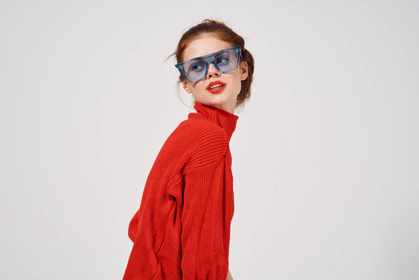 woman in red sweater jeans blue glasses side view - Foto, Imagen