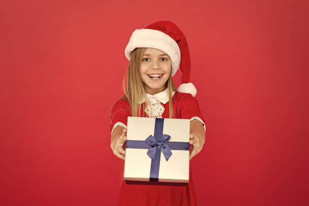 Cheerful kid carnival costume red background. Surprise for her. Happy winter holidays. Small girl opening gift. New year. Santa claus gift. Little girl child received gift. Present xmas. Magic moment - Φωτογραφία, εικόνα