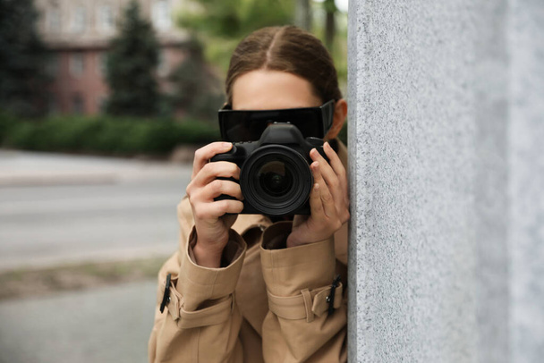 Private detective with modern camera spying on city street - Zdjęcie, obraz