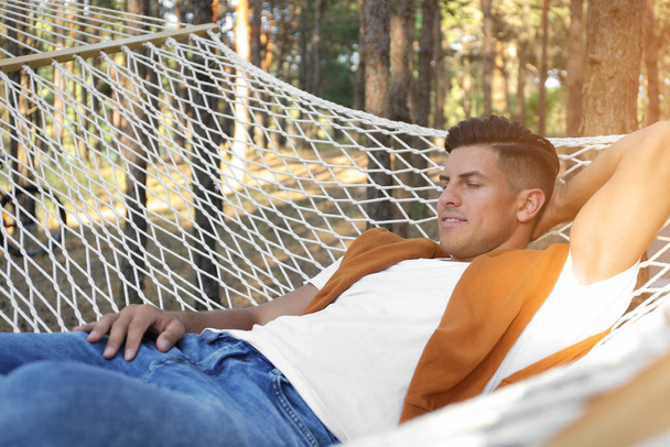 Handsome man resting in hammock outdoors on summer day - Foto, Imagem