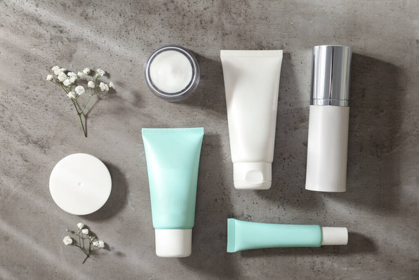 Set of luxury cosmetic products on grey table, flat lay - Фото, зображення