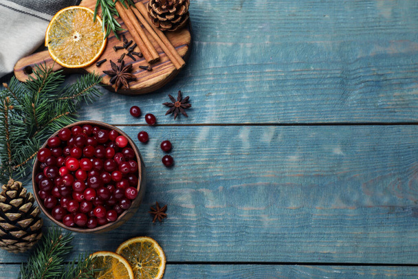 Flat lay composition with fresh ripe cranberries on blue wooden table. Space for text - Photo, image