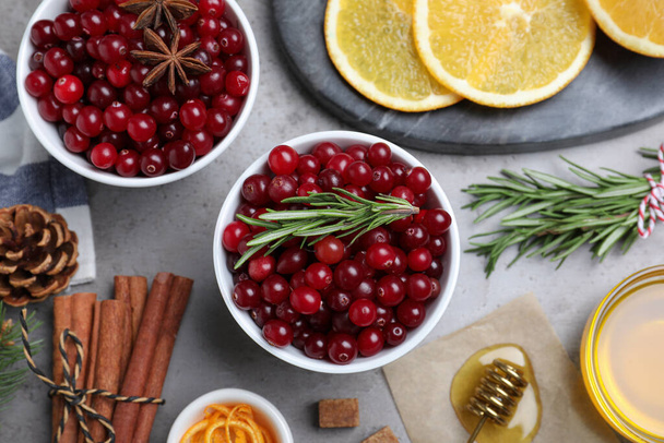 Flat lay composition with fresh ripe cranberries on grey table - Photo, image