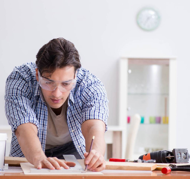 Young man in woodworking hobby concept - Foto, imagen