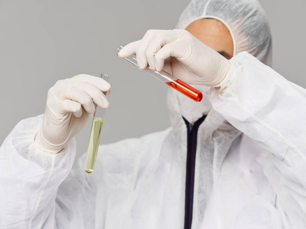 Male laboratory assistant mixes solutions vaccine development research science - Foto, imagen