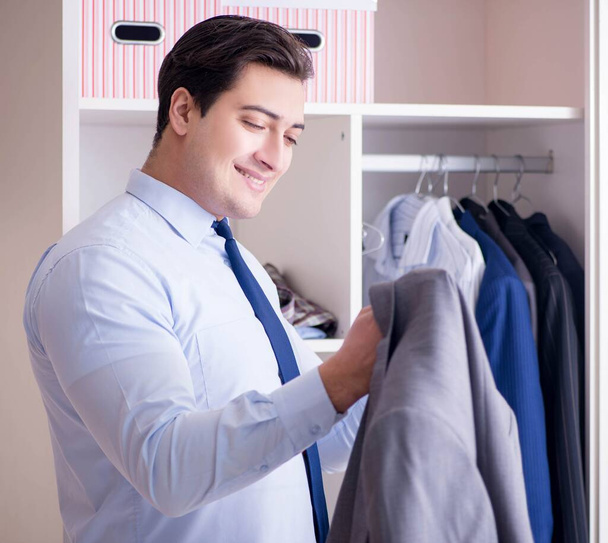 Young man businessman getting dressed for work - Photo, Image