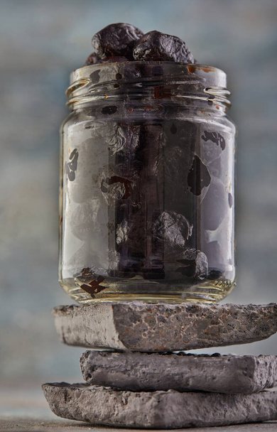 Fermented vegetarian canned food concept. Pickled black olives in a glass jar. The concept of canned food. - Photo, Image