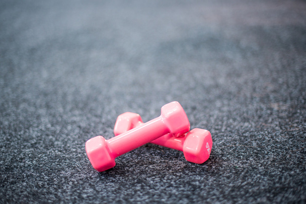 Dumbbells on the carpet in the gym - Фото, зображення