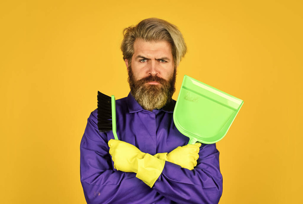 Gardener cleaning service man. Cleaning agency. Worker with brush. Cleaning equipment. Yardman occupation. Garbage removal. Cleaning day. Janitor professional. Bearded hipster blue uniform with broom - Foto, Bild