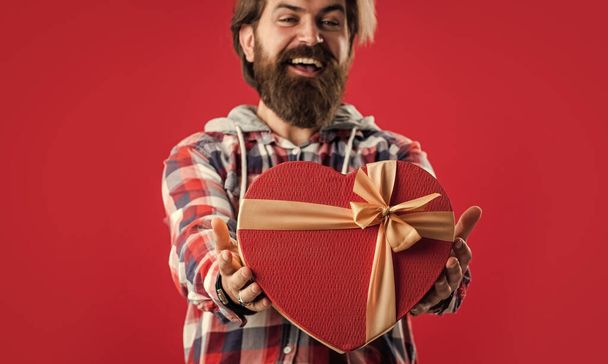 Feeling happiness. brutal mature hipster give heart box. perfect gift for her. bearded man express love. love holiday. male go shopping. boxing day concept. valentines day present. be my valentine - Photo, Image