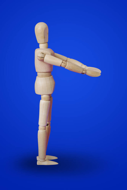 Sports fitness wooden toy figure on blue background - Фото, зображення