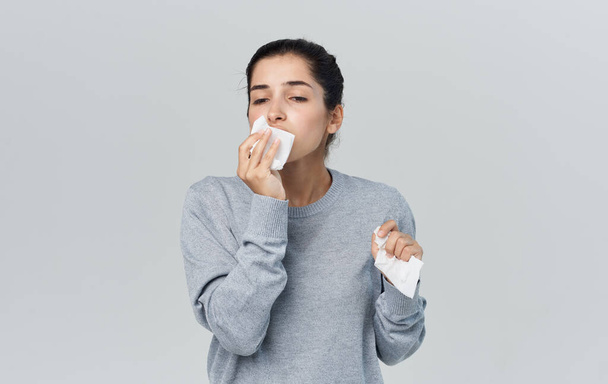Woman runny nose health problems gray sweater napkin - Valokuva, kuva